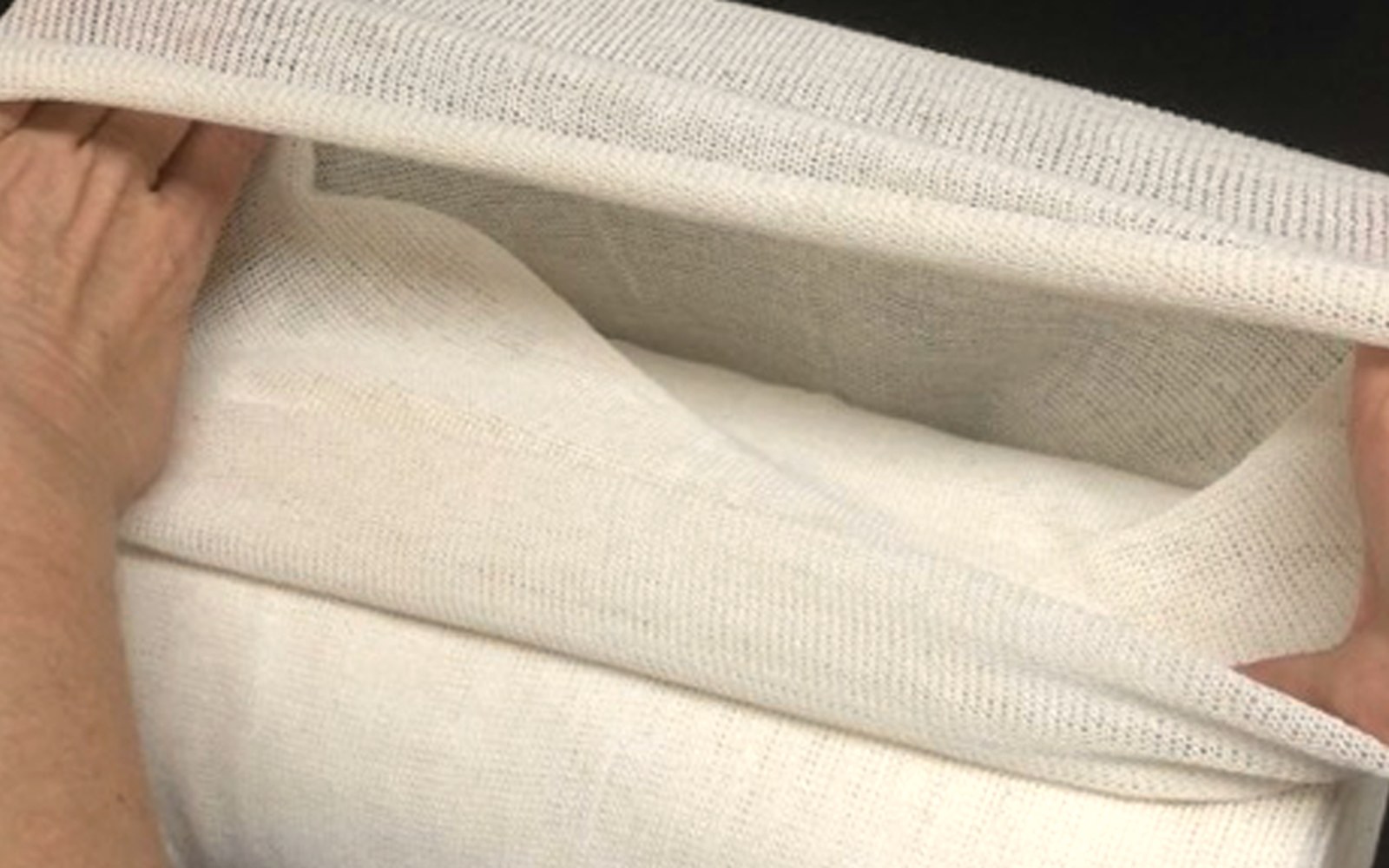 Hands showing the breathable stockinette weave
